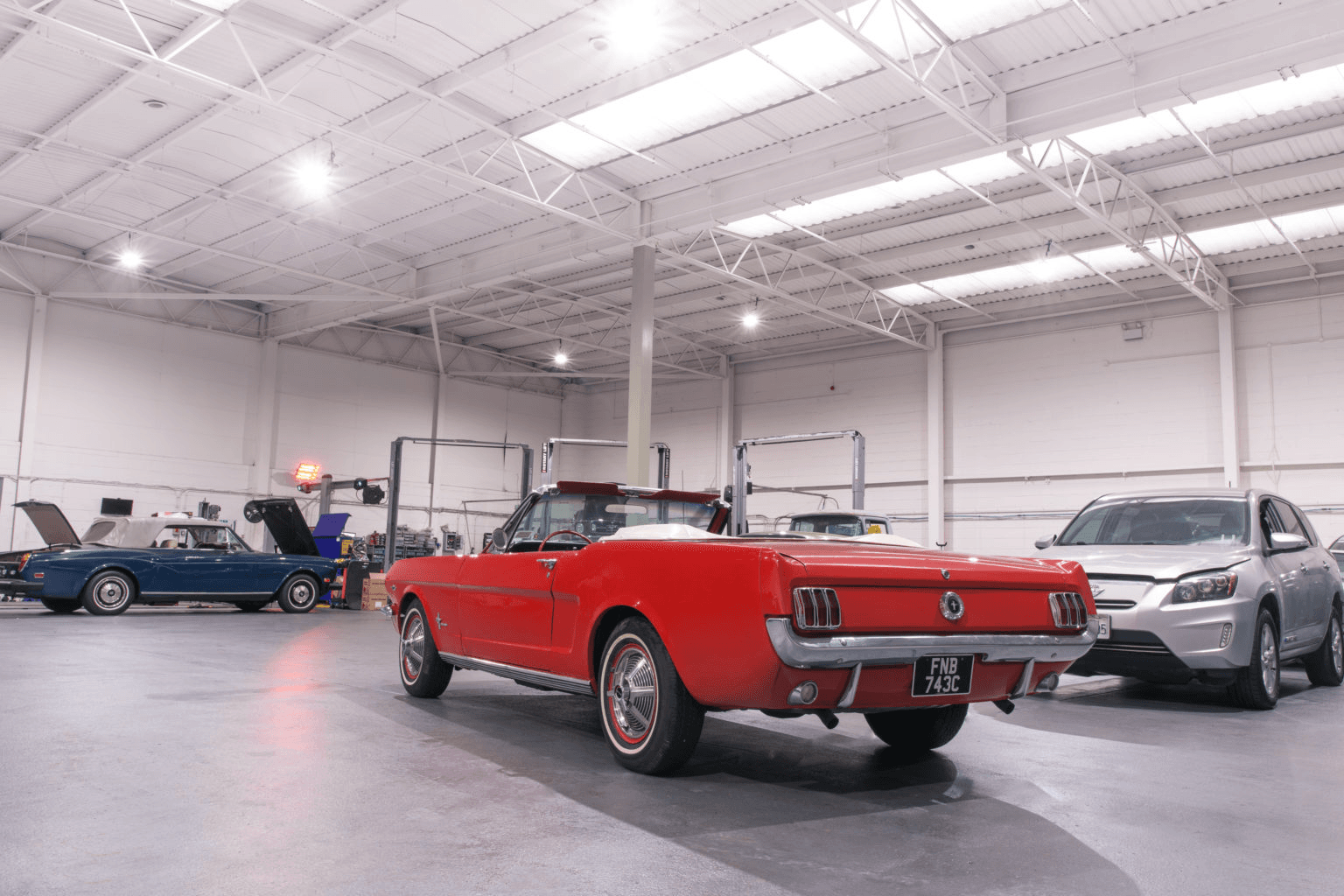 A 1965 Ford Mustang in the ShipMyCar workshop