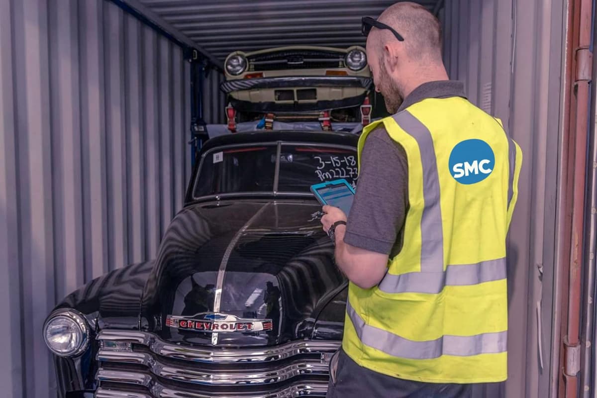 Professional car unloading from a shipping container at ShipMyCar