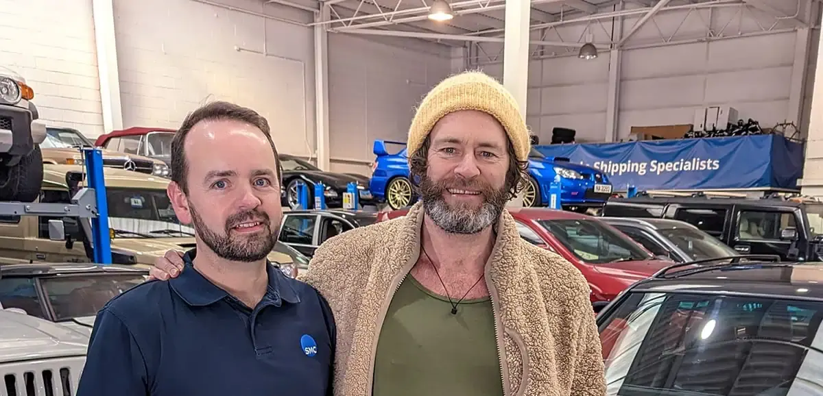 ShipMyCar team member with a client in our workshop