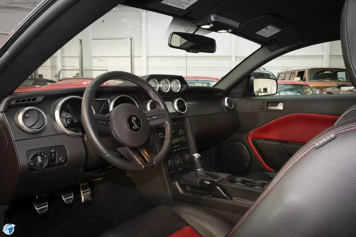 Shelby Super Snake interior with black dashboard, Shelby steering wheel and red seat trim