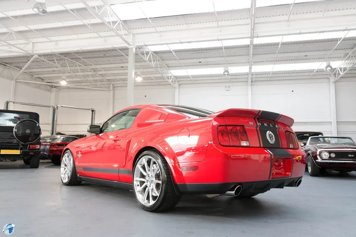 Rear quarter of a red Shelby Super Snake showing its three-section rear lenses