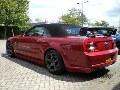 Red Mustang convertible with a rear spoiler and replacement rear light clusters