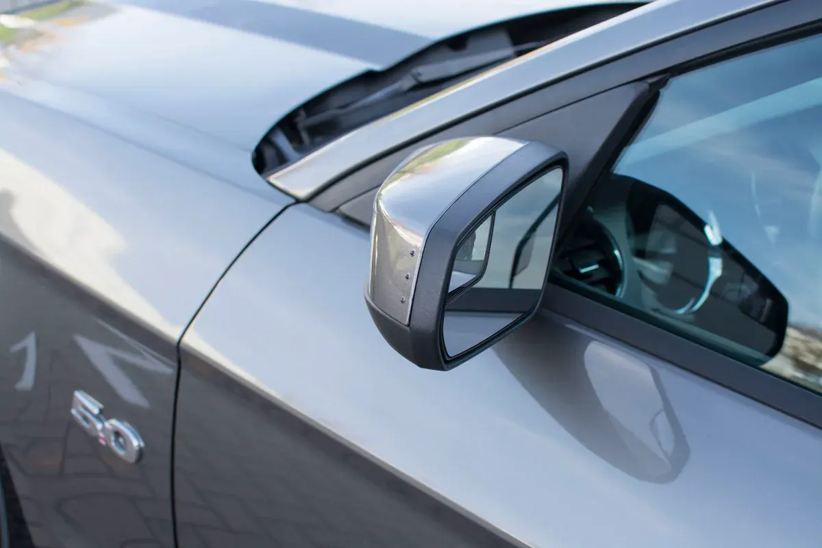 Small side indicator lights integrated into a silver Mustang wing mirror