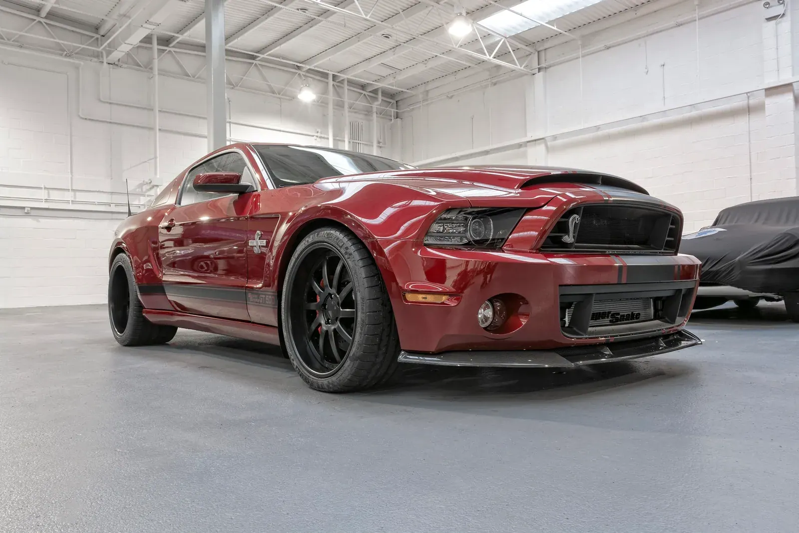 Red 2014 Shelby GT500 Super Snake with black wheels in the ShipMyCar workshop