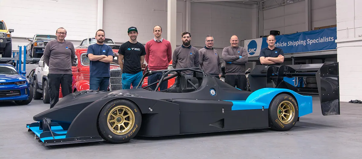 The ShipMyCar team with a race car in our workshop