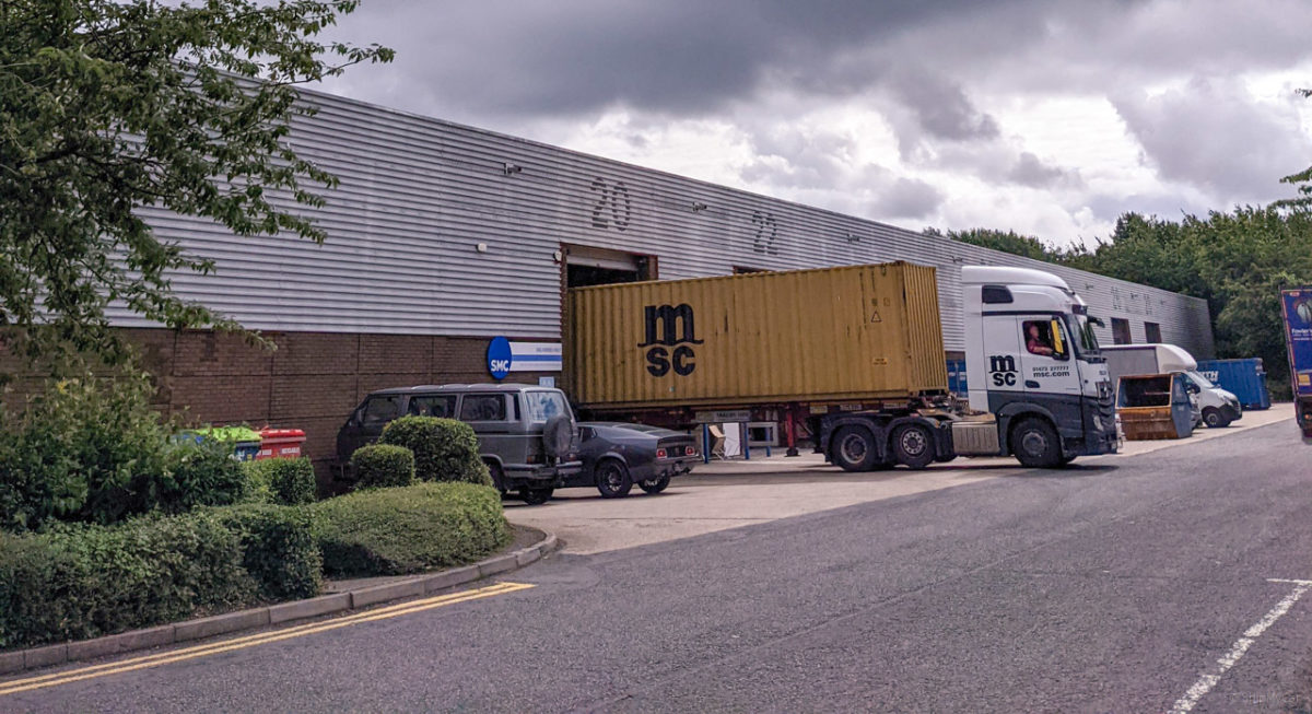 container lorry unloading cars